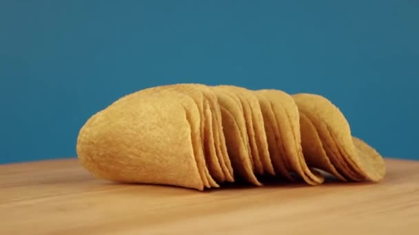 Croustilles de pomme de terre filant sur un fond bleu — Video
