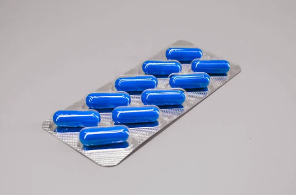 Package with blue capsules in the amount of ten pieces — Stock Photo, Image