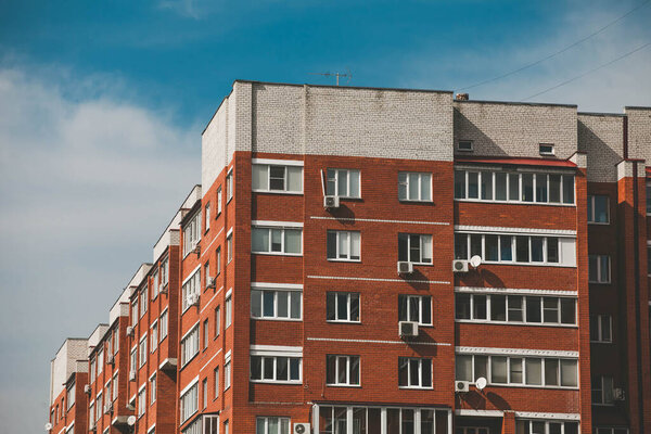 red brick apartments building against the sky