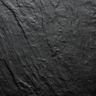 Siyah, vahşi taştan yapılmış doğal bir arka plan. Yukarıdan görüntüle