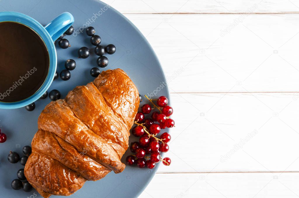 Classic English breakfast: a ruddy croissant with forest berries