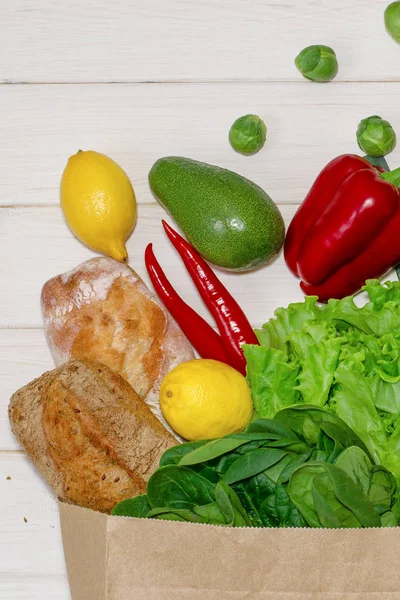 A vegetable set from the supermarket in a paper bag. Buying organic food