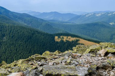Sıradışı dağ yürüyüşleri. Sisteki yüksek sıradağların zeminine karşı yeşil oklarla kaplanmış devasa taşlar.