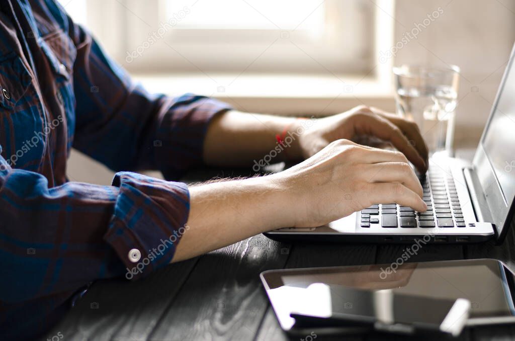Freelancer works in home office during coronavirus pandemic. Open laptop with blank screen on a white background top view