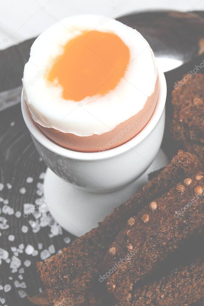 Healthy food. English breakfast with boiled egg and croutons on a white wood background. Healthy breakfast