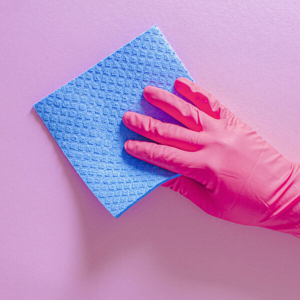Hand in rubber glove with wipe for cleaning wipes the surface from dust, dirt and bacteria. Commercial cleaning company concept