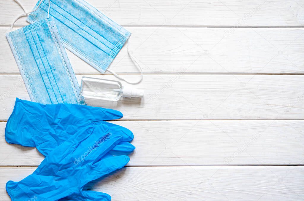 Anti-virus content. Protective medical masks, sterile gloves and antiseptic lie on a white background