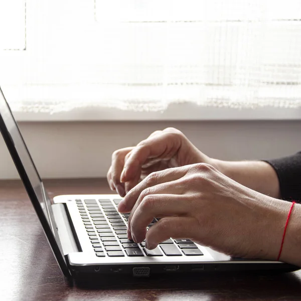 Freelancer works in home office on self-isolation during pandemic. Business work on laptop