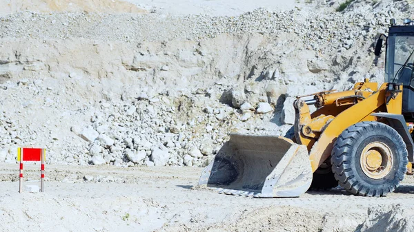 Bucket Excavator lying on the ground on the construction of the road.