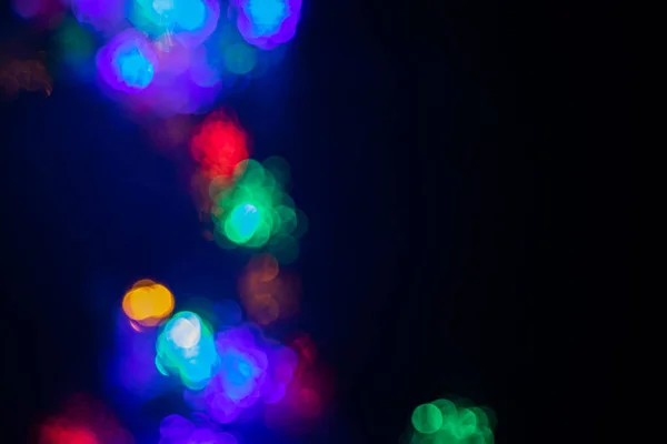 Multicolor světla na černém pozadí s bokeh efekt výplně — Stock fotografie