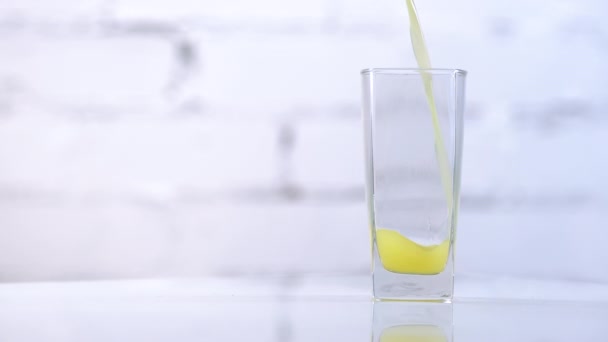 Taze Sıkılmış Portakal Suyu Masadaki Bardağa Dökülüyor Beyaz Arkaplanda Sarı — Stok video