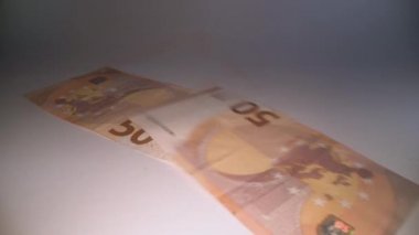 Avro banknotları karanlık arka planda düşüyor. Tasarruf ve yatırım, gölge ekonomi