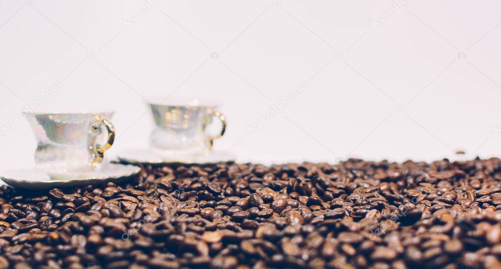 Retro style coffee beans on a white background and two cup