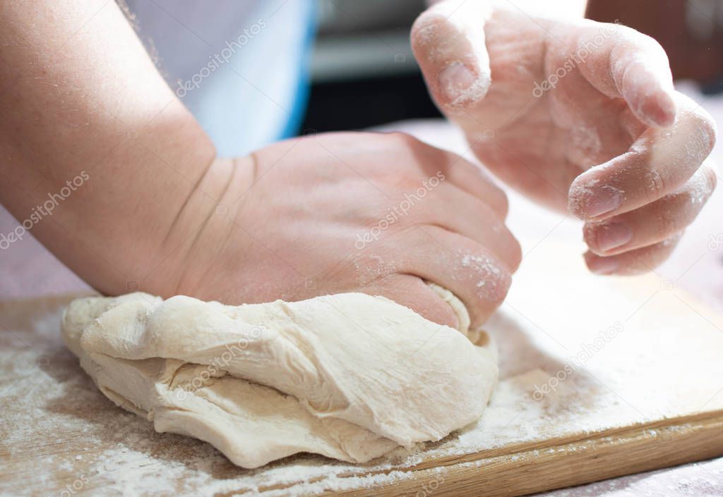 Knead the dough on a wooden board
