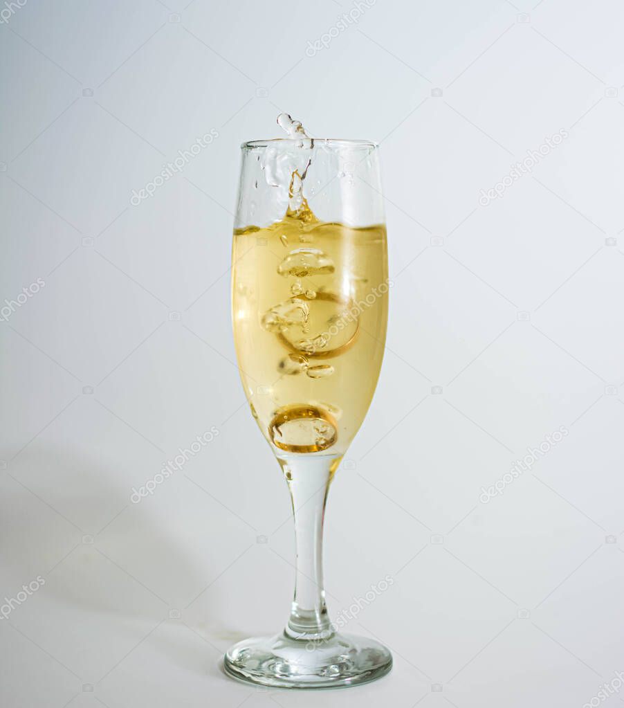 Glass of wine wedding rings spra