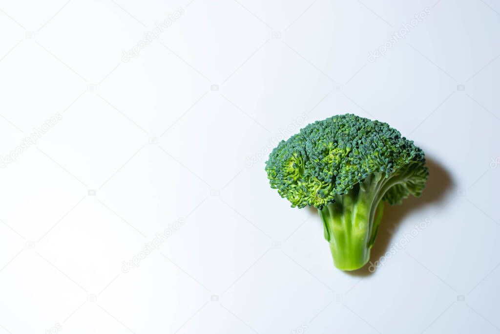 Natural broccoli on a white background close-up, there is a place for notes.
