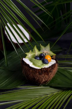 Hindistan cevizli meyve püresi ve arka planda yapraklar.