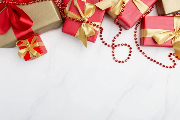 Festive present boxes at white background with golden ribbons — 스톡 사진