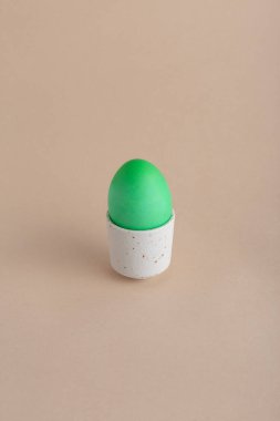 Paskalya bej arka planında yeşil paskalya yumurtası var. Metin için Paskalya arkaplanı kavramı