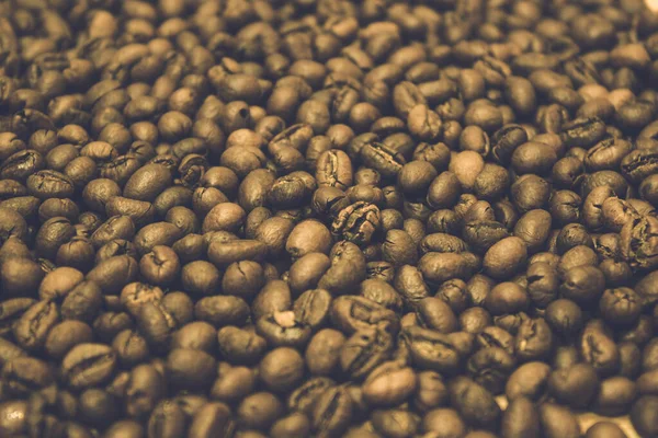 Roasted dry brown grains of Vietnamese delicious aromatic invigorating coffee