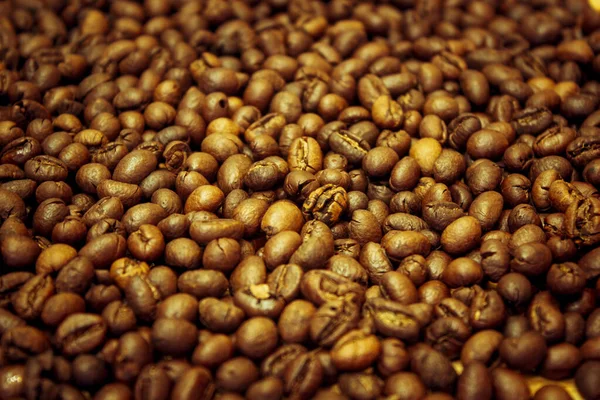 Roasted dry brown grains of Vietnamese delicious aromatic invigorating coffee