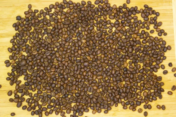 Roasted dry brown grains of Vietnamese delicious aromatic invigorating coffee