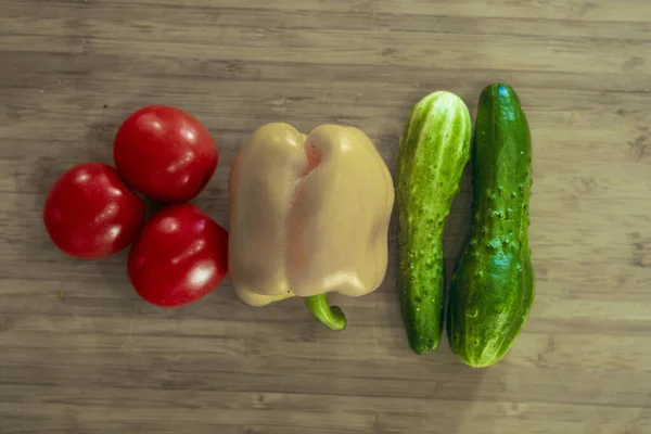 Traffic light from vegetables: red tomato, yellow pepper, green cucumber