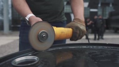 Adam Açısal Öğütme Makinesini Kesiyor Demir, 120 fps açıyla kıvılcımlar saçıyor. Metal açı öğütücüsünde kıvılcımlar çıkıyor. İşçi endüstriyel öğütücü kullanıyor. 120 fp. Yavaş çekim.
