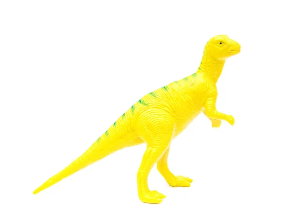 Juguete dinosaurio plástico amarillo vista lateral sobre un fondo blanco — Foto de Stock