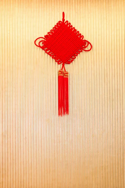 Chinese knot a good luck symbol hanging on wall — Stock Photo, Image