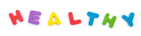 Palabra de saludable formado por rompecabezas de alfabeto en blanco — Foto de Stock