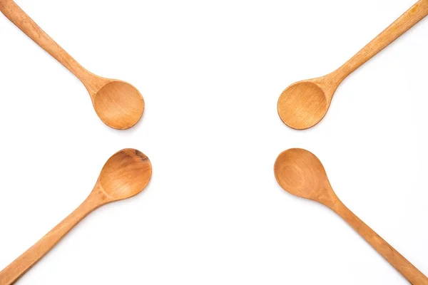 Four empty wooden spoons on white background — Stock Photo, Image