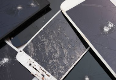 several broken smart phone screens on a white background clipart