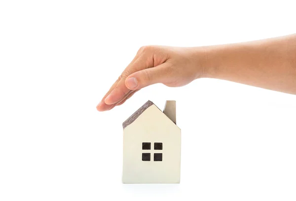 Right hand covering a small family house with clipping path, home insurance concept or representing home ownership — Stock Photo, Image