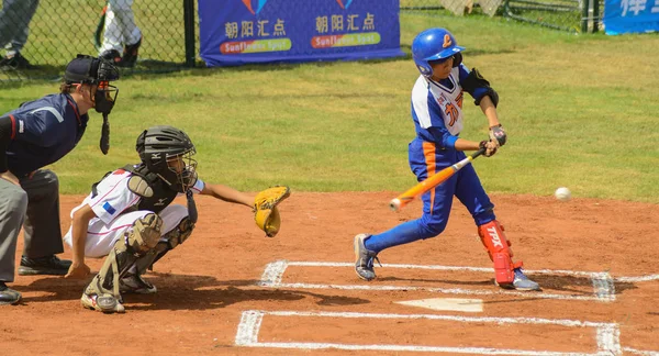 Ununknown batter about to hit the ball — стоковое фото