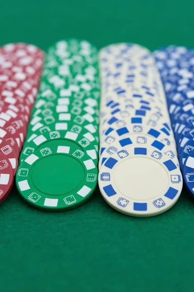 lots of poker chips on casino table vertical