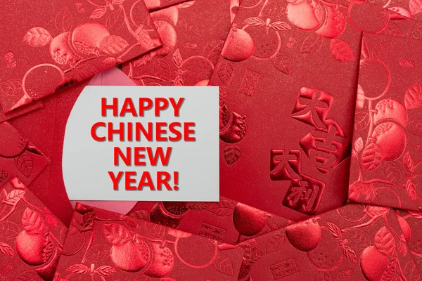 Red pockets with a card written happy chinese new year — Stock Photo, Image