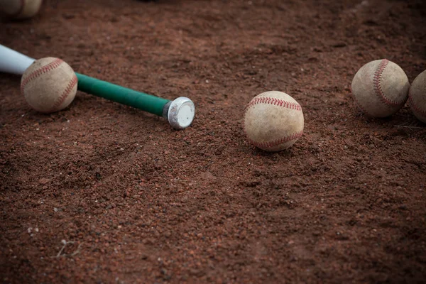Baseball bat and balls on floor — Stock Photo, Image