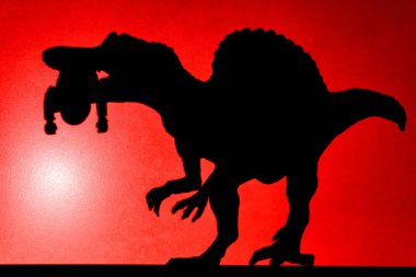 Hiçbir logo veya marka projeksiyon gölgesi bir spinosaurus ağzında bir ceset ile kırmızı nokta ışık