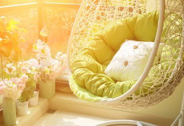garden swing with mattress and cushion in a balcony in the morning clipart