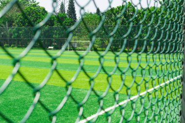 a soccer field behind the fence clipart