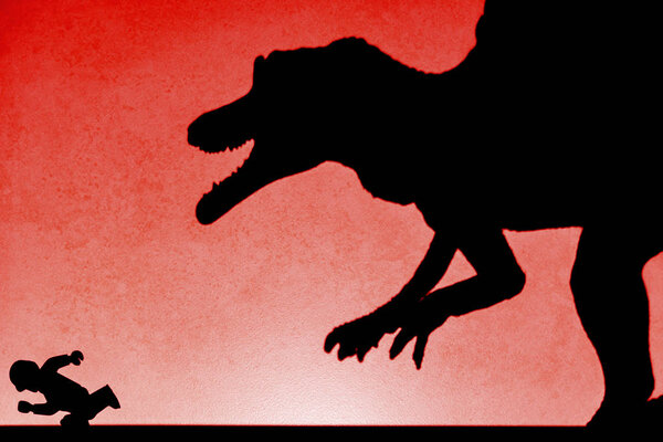 shadow of spinosaurus chasing human  on wall in red