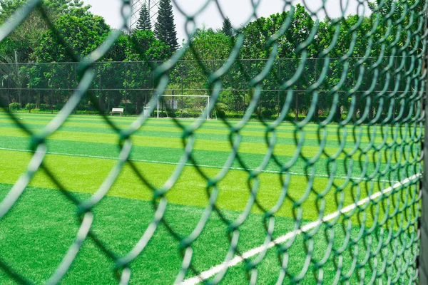 Um campo de futebol atrás da cerca — Fotografia de Stock