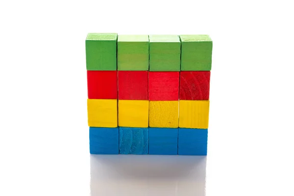 Colorful wooden toy blocks stack up on a white background — Stock Photo, Image