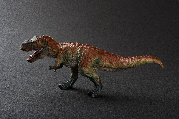 Tyrannosaurus toy on a dark background — Stock Photo, Image