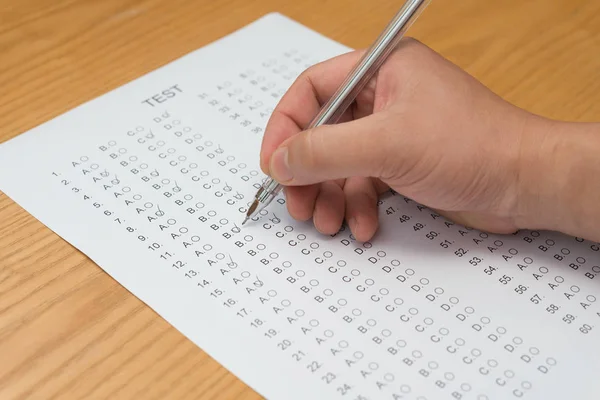 Filling test score sheet with ballpoint — Stock Photo, Image
