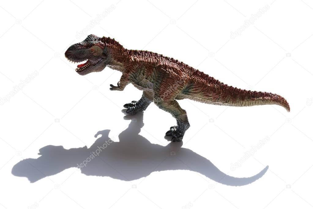 tyrannosaurus toy with shadow on a white background
