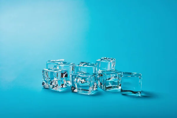 Ice cubes on a blue background — Stock Photo, Image