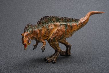 acrocanthosaurus oyuncak ile karanlık bir arka plan üzerinde gölge