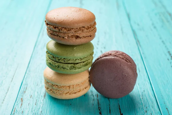 Studio shoot of colorful macaroons stack up on a blue background — Stock Photo, Image